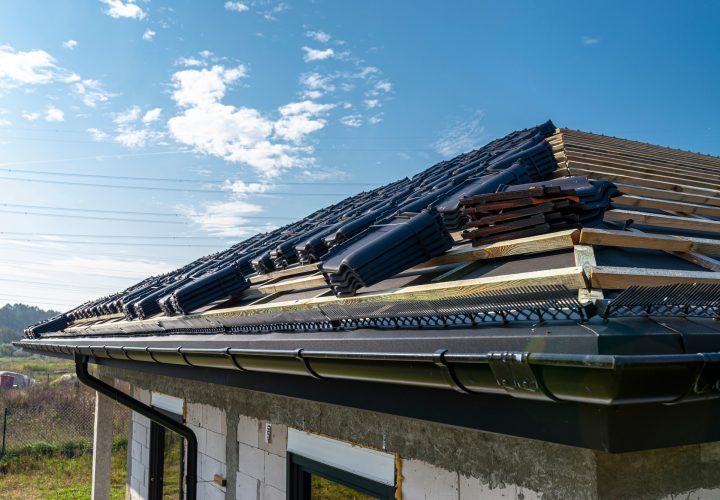 Roof ceramic tile arranged in packets on the roof on roof battens. Preparation for laying roof tiles